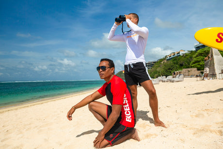Two men standing on beach at Canna Resort Bali wearing cmgarmindo manufactured swimwear.