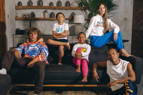 Adults and kids sitting on sofa wearing leisurewear manufactured by CM Garmindo